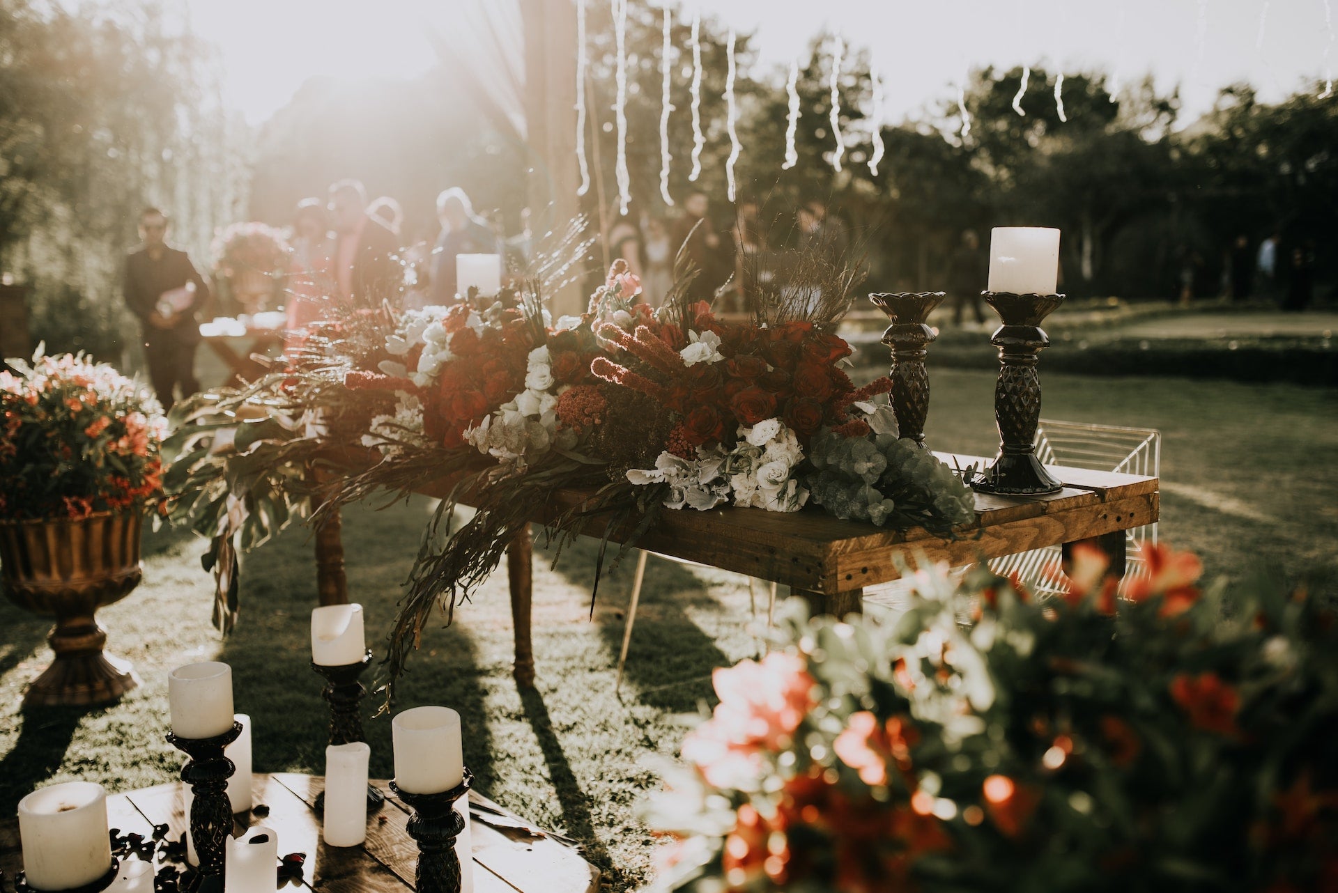 Assorted flowers and candles arranged on the table