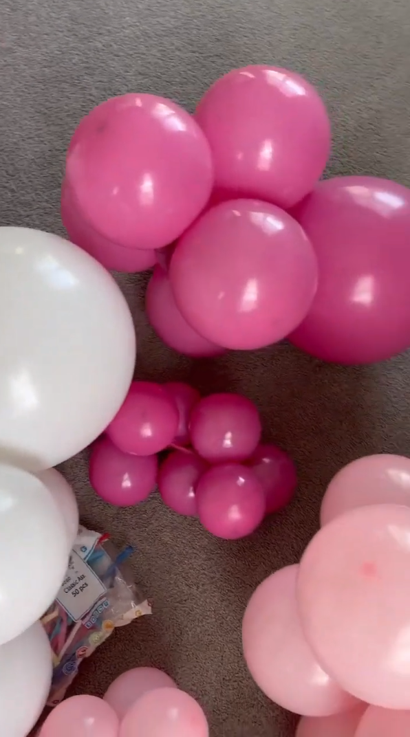 Clusters of pink, blush, and white balloons