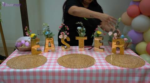 Gold-plated ceramic letter sculpture vases filled with baby's breath flowers