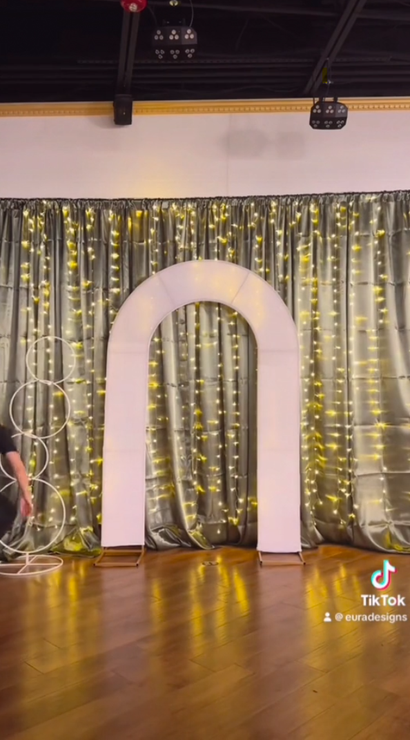 Wedding arch with fitted cover and a backdrop curtain behind