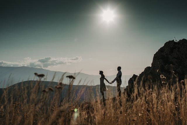 Couple standing on top of a mountain