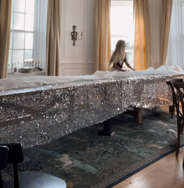 Person laying out a sequin tablecloth and table runner