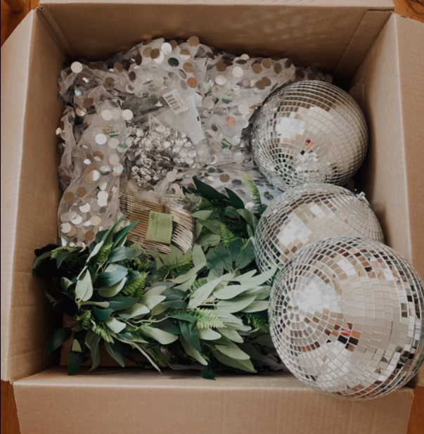 Disco balls, greenery, sequin tablecloths in a box