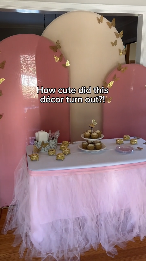 Backdrops with fitted covers and table designed with table linens, disposable dinnerware, and cupcake stand