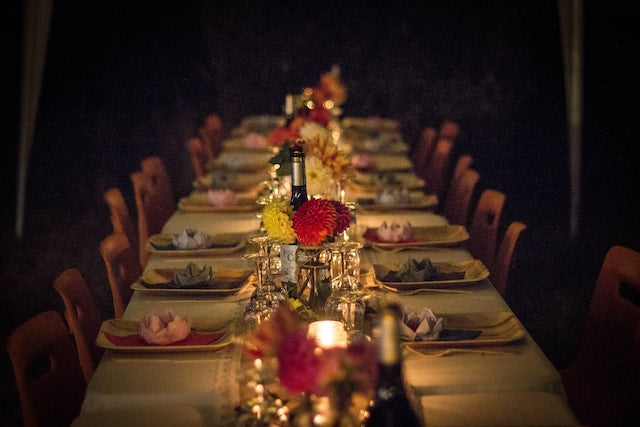 Table setting with disposable dinnerware, flowers, centerpieces, and candles