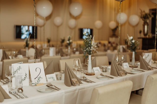 Wedding tablescape with floral decor and festive balloons.