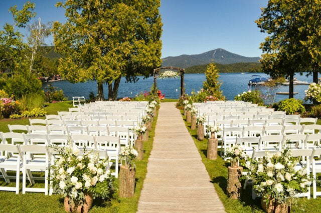 Wedding venue with aisle runner, backdrop, flowers, and greenery