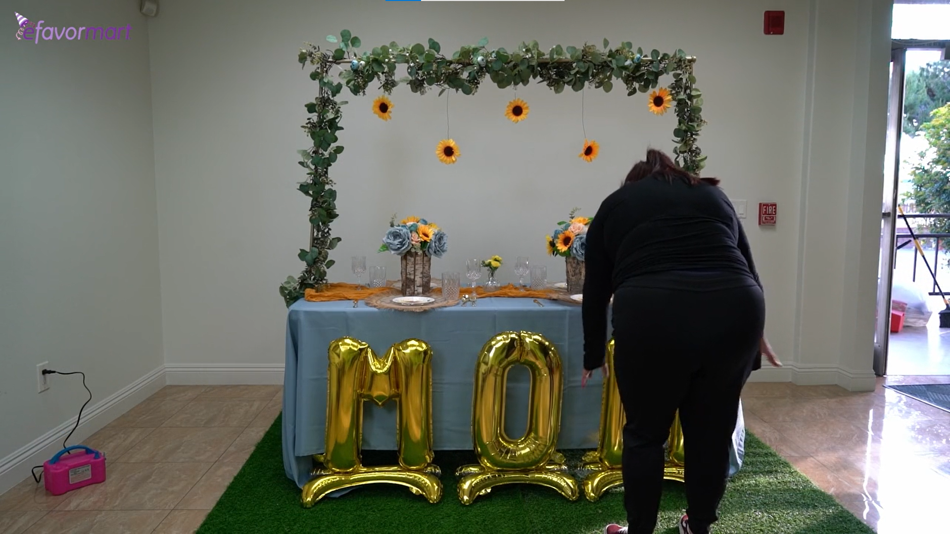 Person setting up inflated letter balloons