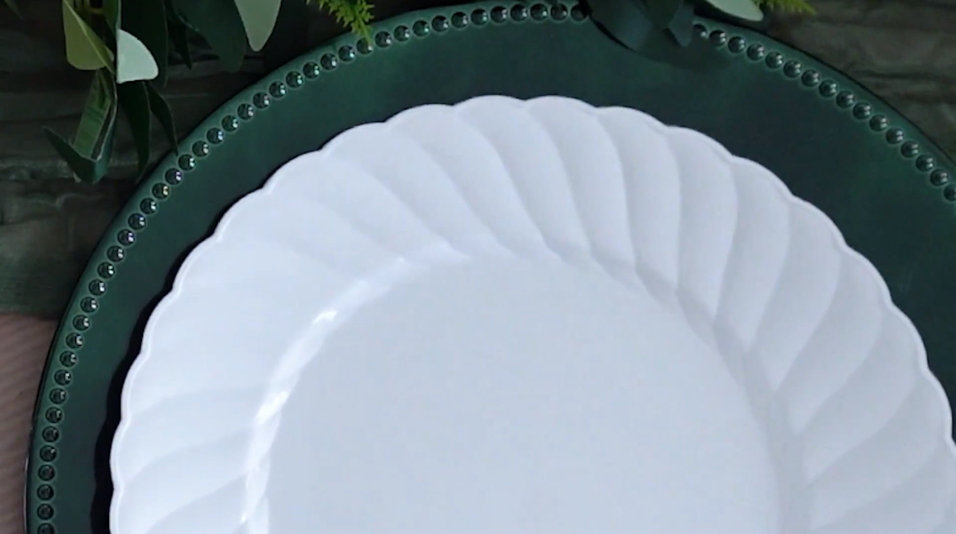 Green acrylic charger plate and white dinner plate combination