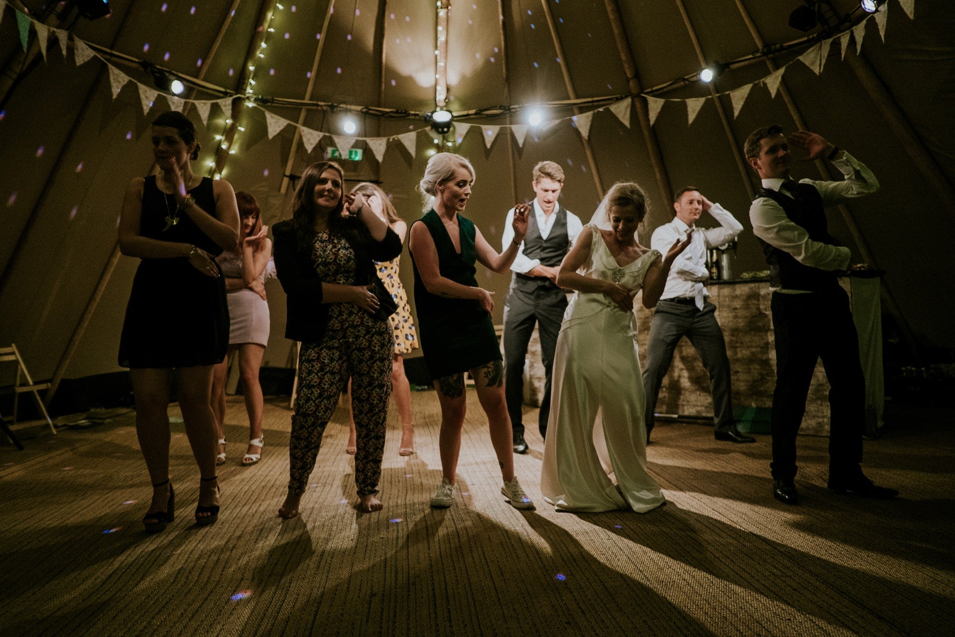 Guests dancing with the bride and groom