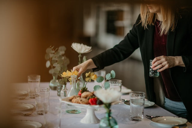 Table setup with table linens, disposable dinnerware, and floral centerpiece