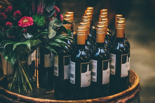 Wine bottles on a decorative tray with flowers