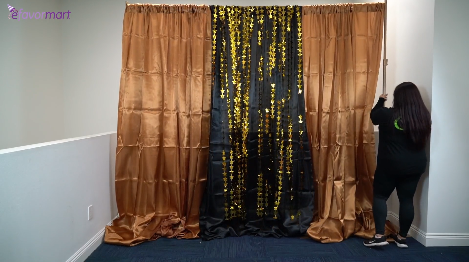 Photo backdrop using satin curtains and gold foil fringe