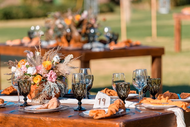 Colorful wedding tablescape with floral centerpiece and rustic charm.