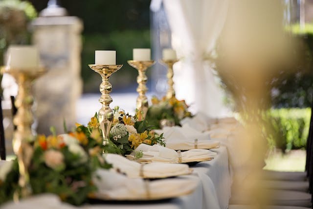 Candle holders with candle and flower arrangement centerpiece