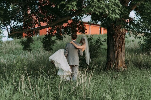 Bride and groom in forest with lush greenery