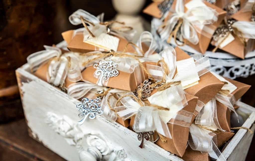 A white box full of wrapped wedding favors