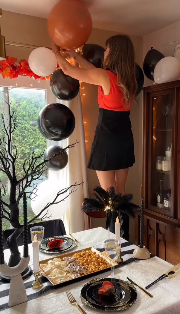 Woman setting up the balloon garland