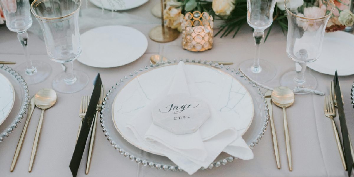 table setting with napkins, glassware, and floral decor