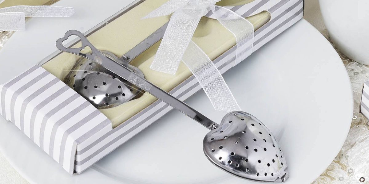 Heart shaped tea infuser on striped box with white ribbon detail for useful party favor ideas