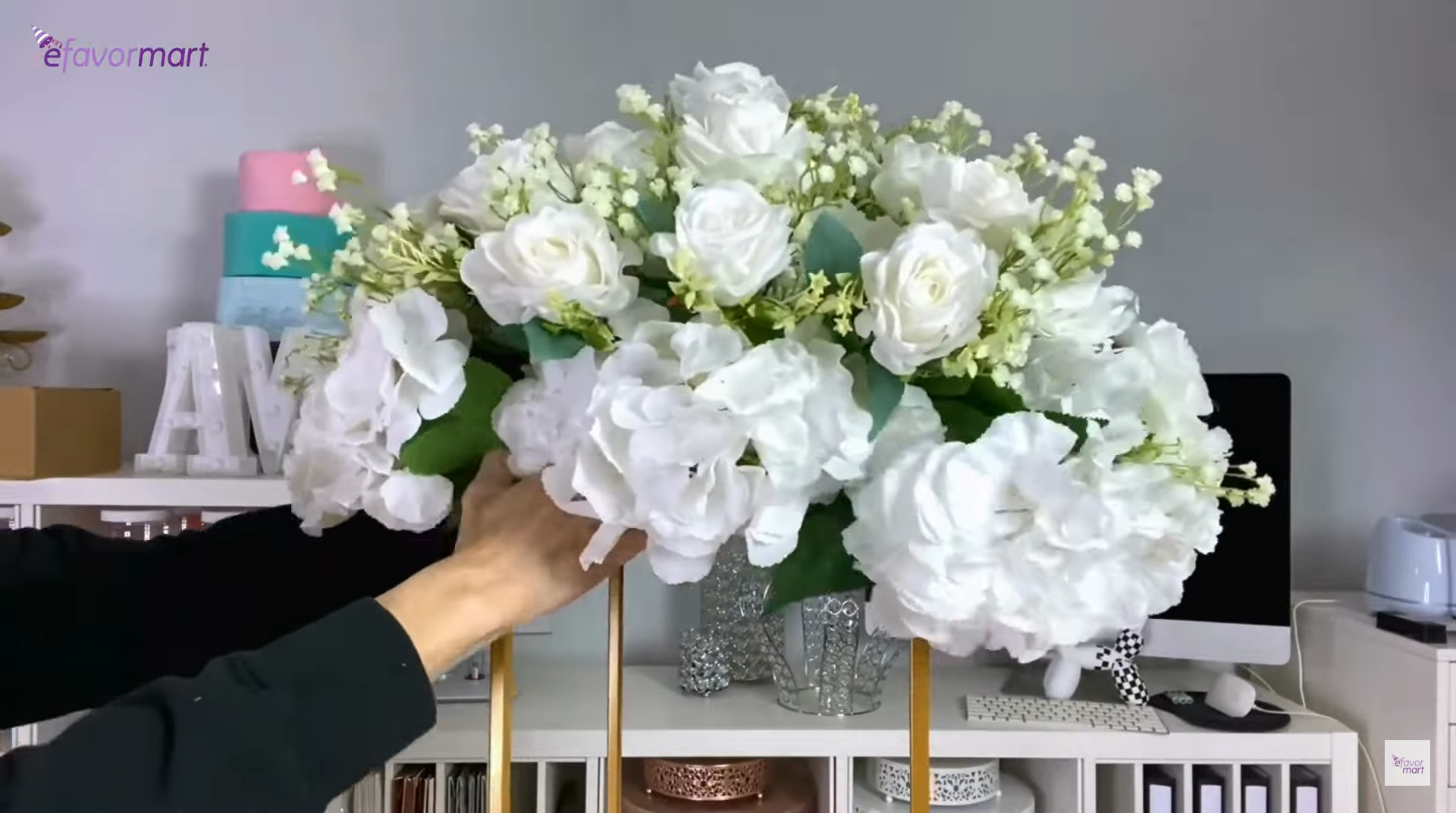 Placing a wedding floral arrangement in a stand