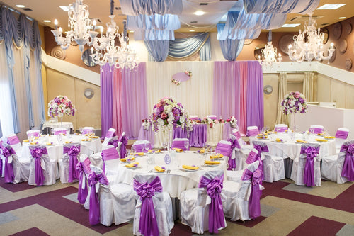 banquet room with chair covers, tablecloths & centerpieces