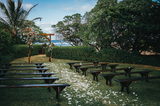 Garden wedding with a wooden arch and benches