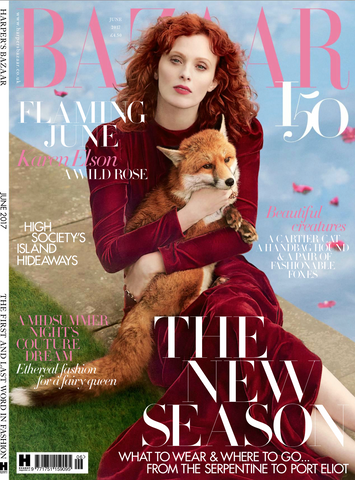 a woman wearing a red dress holding a fox harpers bazaar front cover