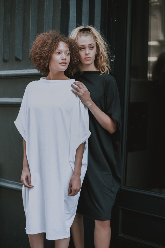 Two women wearing the LBD & Hexagon Shift Dress in black and white featuring a beautiful boat neck by Malaika New York