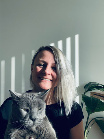 Malaika Boysen Haaning founder of Malaika New York is sitting with her cat Mr. Blob and wishing everyone a lovely galentines