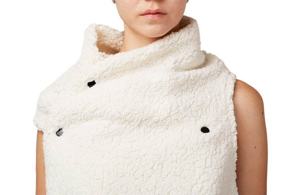 a woman wearing a soft white faux fur vest by Malaika New York
