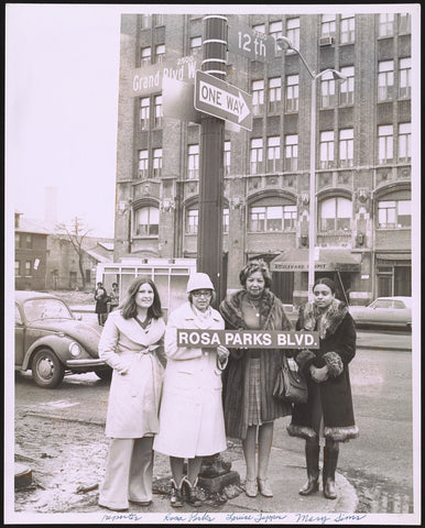 Rosa Parks Holding her Street Sign