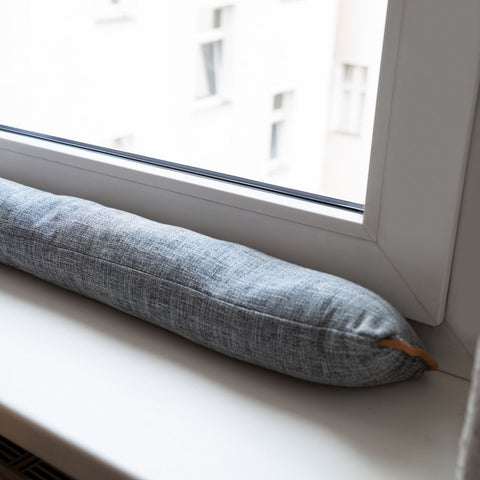 draught excluder on window ledge in home