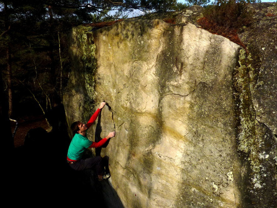 male boulderer on the circuits in fontainebleau