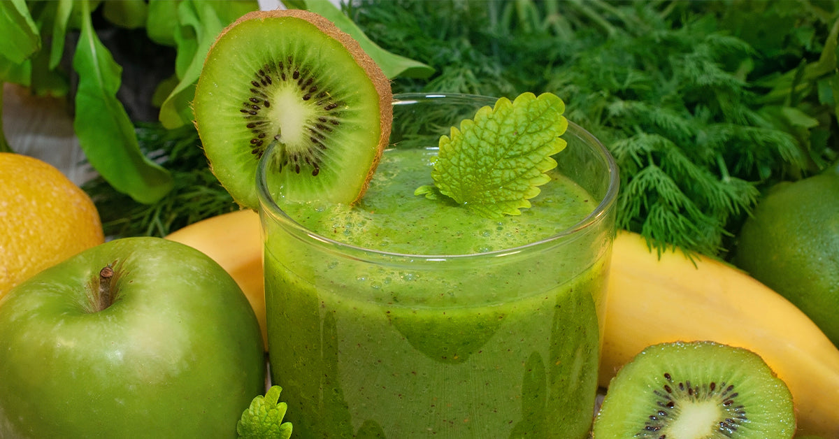 glass of green juice smoothie with apple, kiwi, banana, lemon