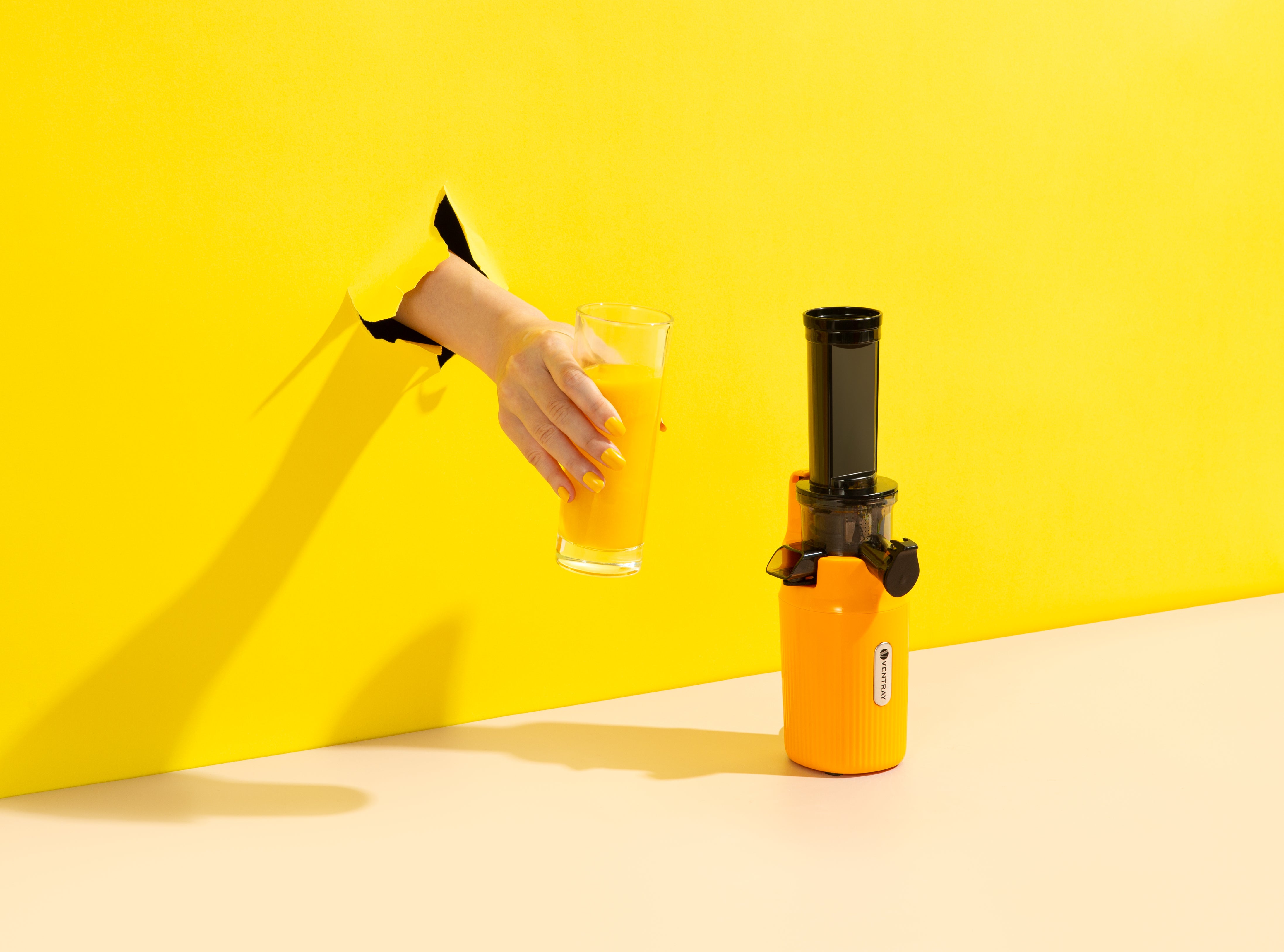 Yellow Ginnie Juicer with Glass of Juice