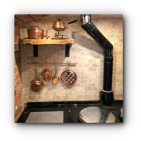 aga stove with copper utensil rail