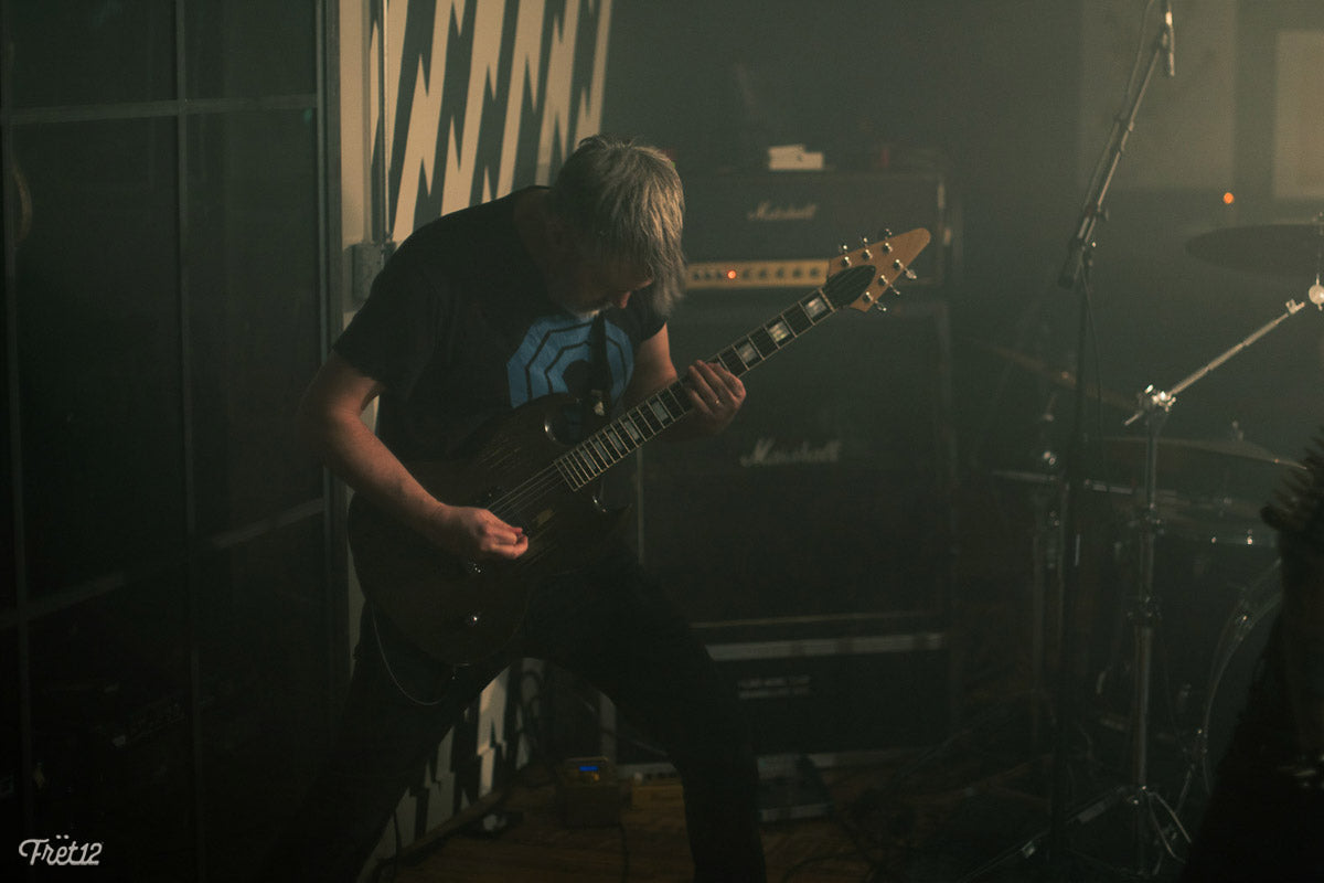 Dallas Thomas of Ready For Death playing a custom built guitar, with a SG Les Paul custom neck and a flying V headstock 