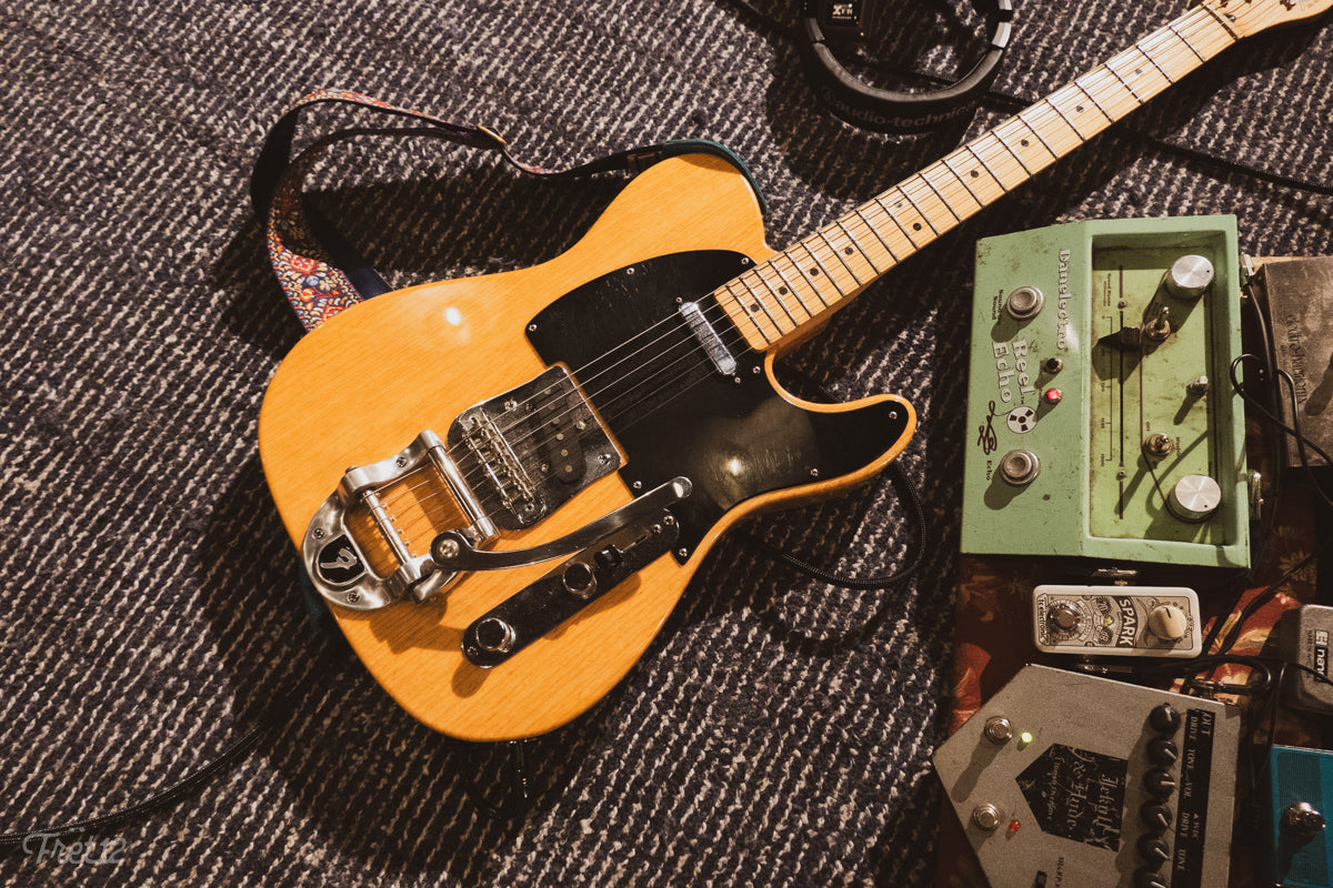 Mexican-made Fender Telecaster with aftermarket bigsby, and Danelectro REEL ECHO guitar pedal.