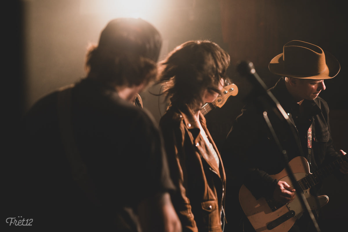 Reilly Downes and Cody Palmer watch as guitarist Justin Eisenbraun plays.