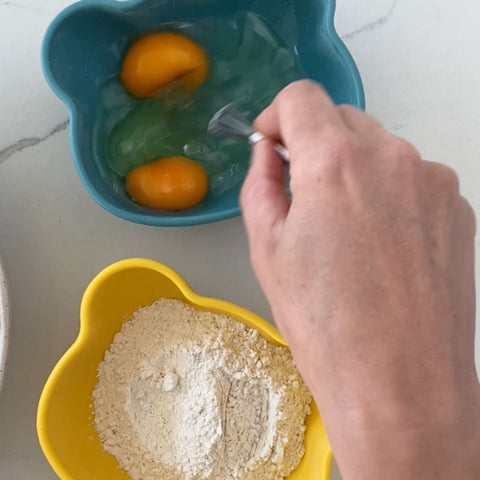place flour and eggs in bowls