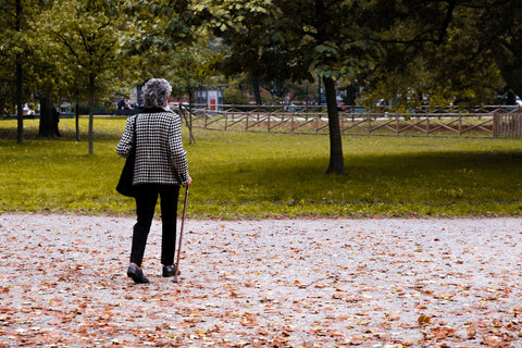 Old Lady Walking with Cane in Danger