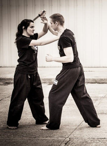 Woman makes a choke hold in self-defense training Stock Photo