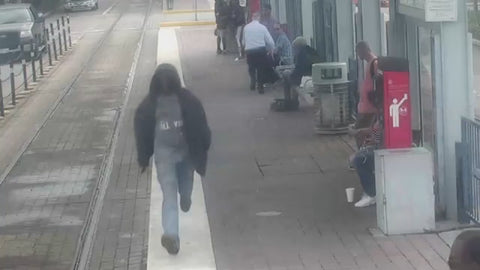 Shooter Wanted Walking Down Train Station Platform