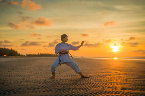 Man practicing Kung Fu on beach