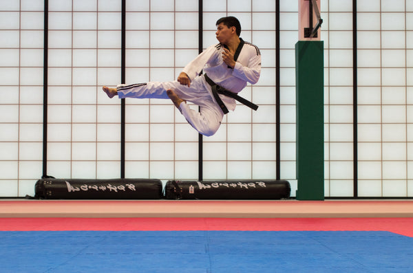 Man Flying Kick in Dojo Karate