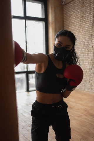 Girl Practicing Self Defense with Punching Bag