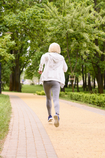 Older Woman Running Away from Danger in Park