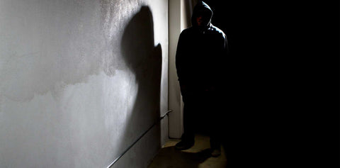 Suspicious Person in Hoodie in Shadows