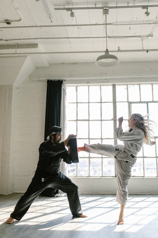 Woman Kicking Pad in Taekwondo Self Defense